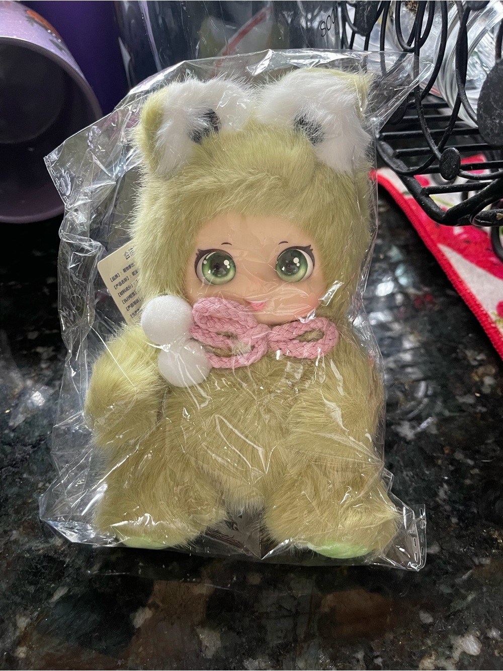Cute small vinyl doll in frog outfit